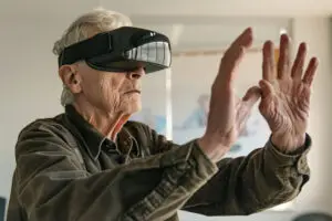 picture of older man trying to touch truth through virtual reality glasses