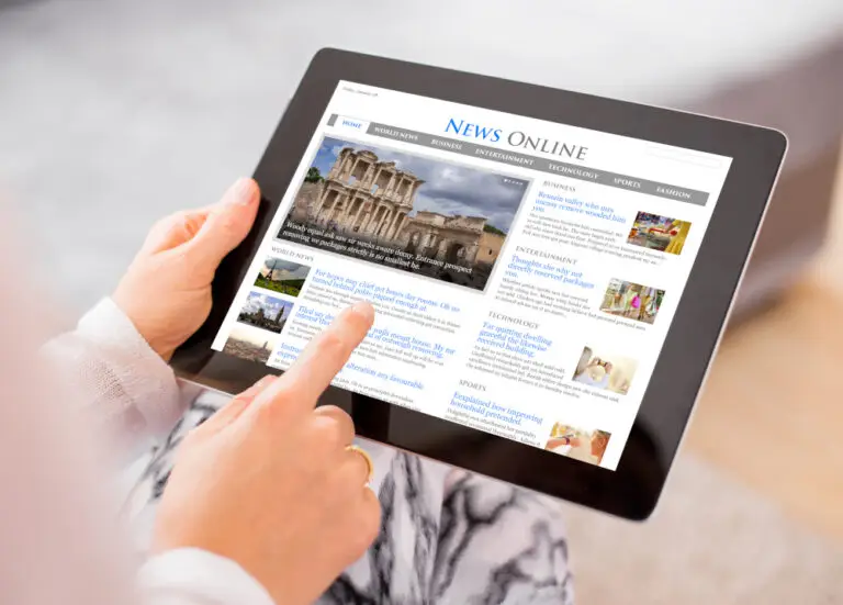 photo of someone checking news on a tablet computer